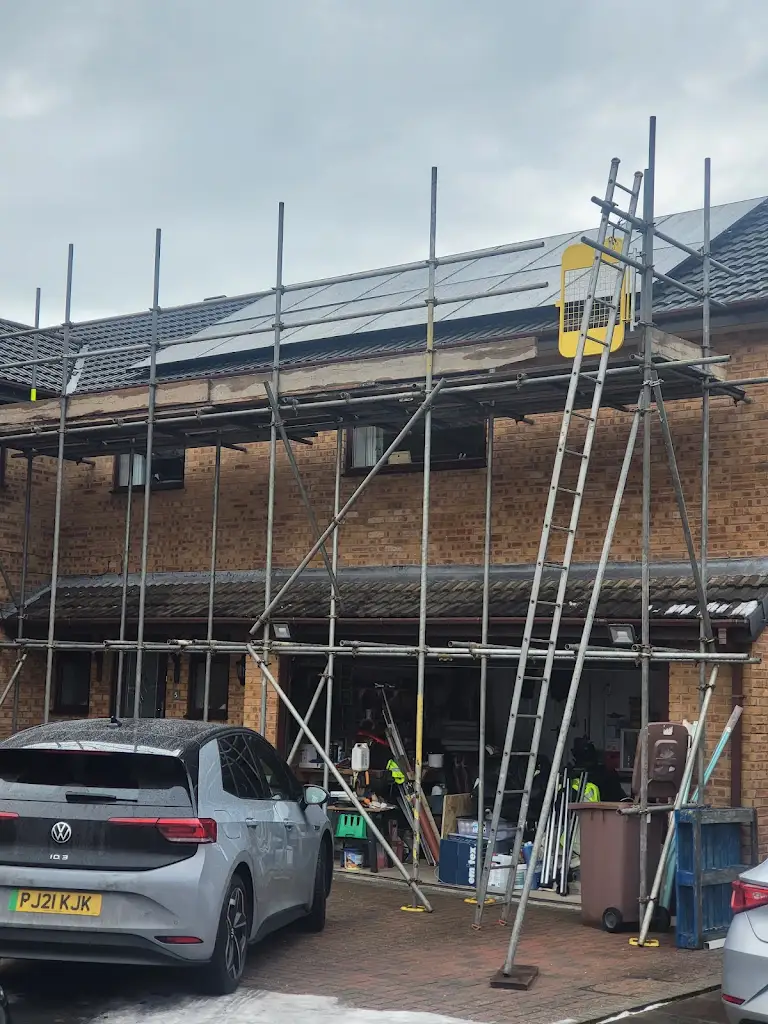 Integral Solar installers fitting solar panels on a Warrington roof
